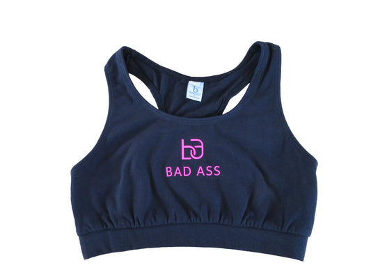 Black racerback sports bra with pink logo and "badass" written on the front, also in pink. 